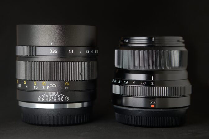 XF 23mm f/2 lens next to the X-Mount Mitakon 35mm f/0.95 ii. The Mitakon stands at 72mm tall and 52mm wide, has a filter thread of 55mm. The lens weighs in at 460g.